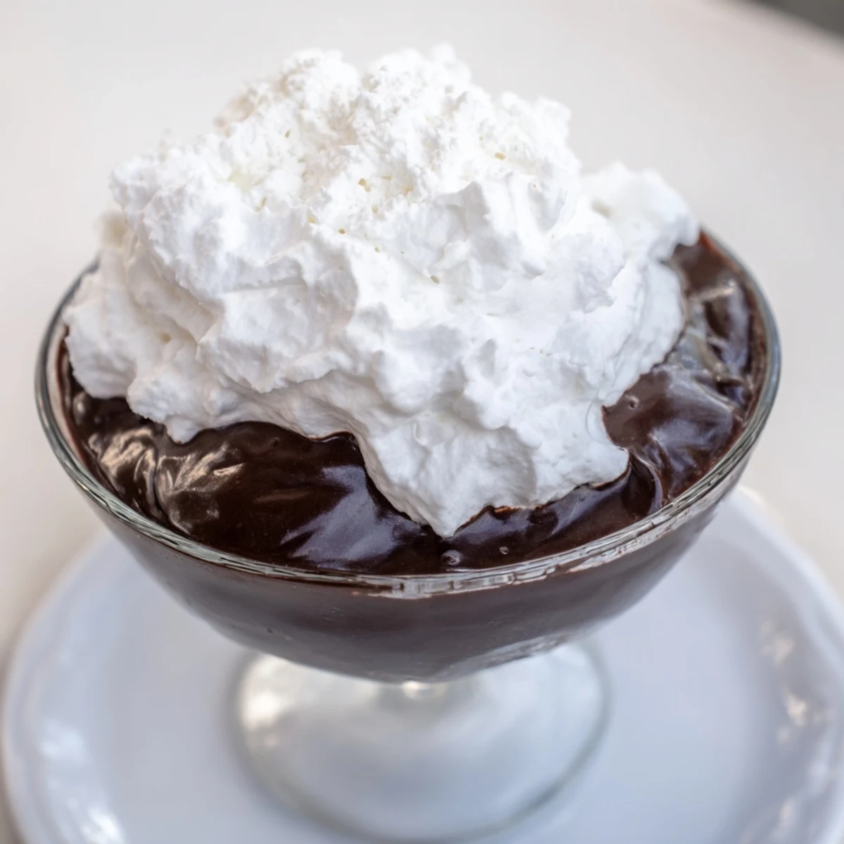 Decadent chocolate mousse with whipped cream: a velvety dessert ready for elegant enjoyment.