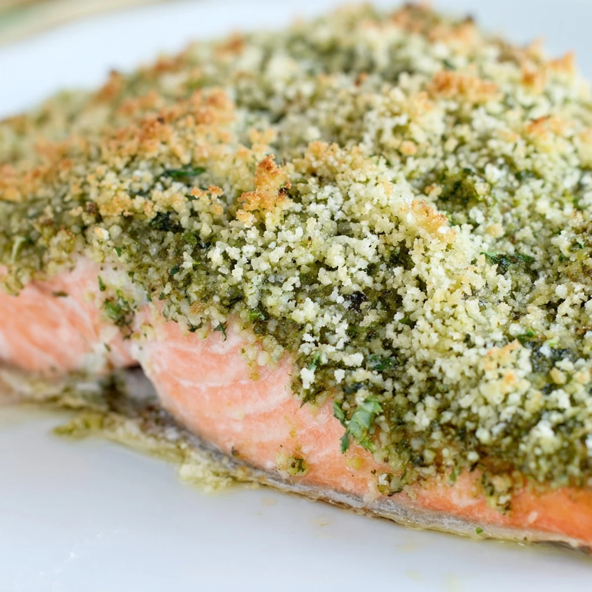 Golden-baked salmon fillet with a vibrant green pesto crust, flaky and moist, ready to serve for dinner.