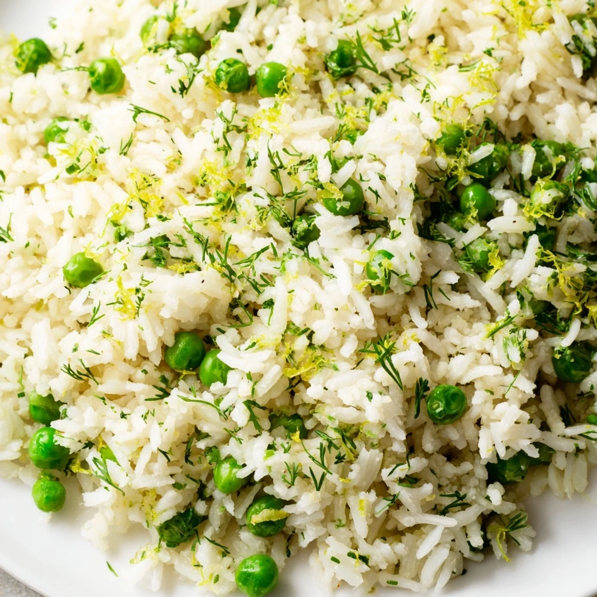 Zesty Lemon Herb Rice Pilaf plated beside grilled chicken for a vibrant Mediterranean meal.
