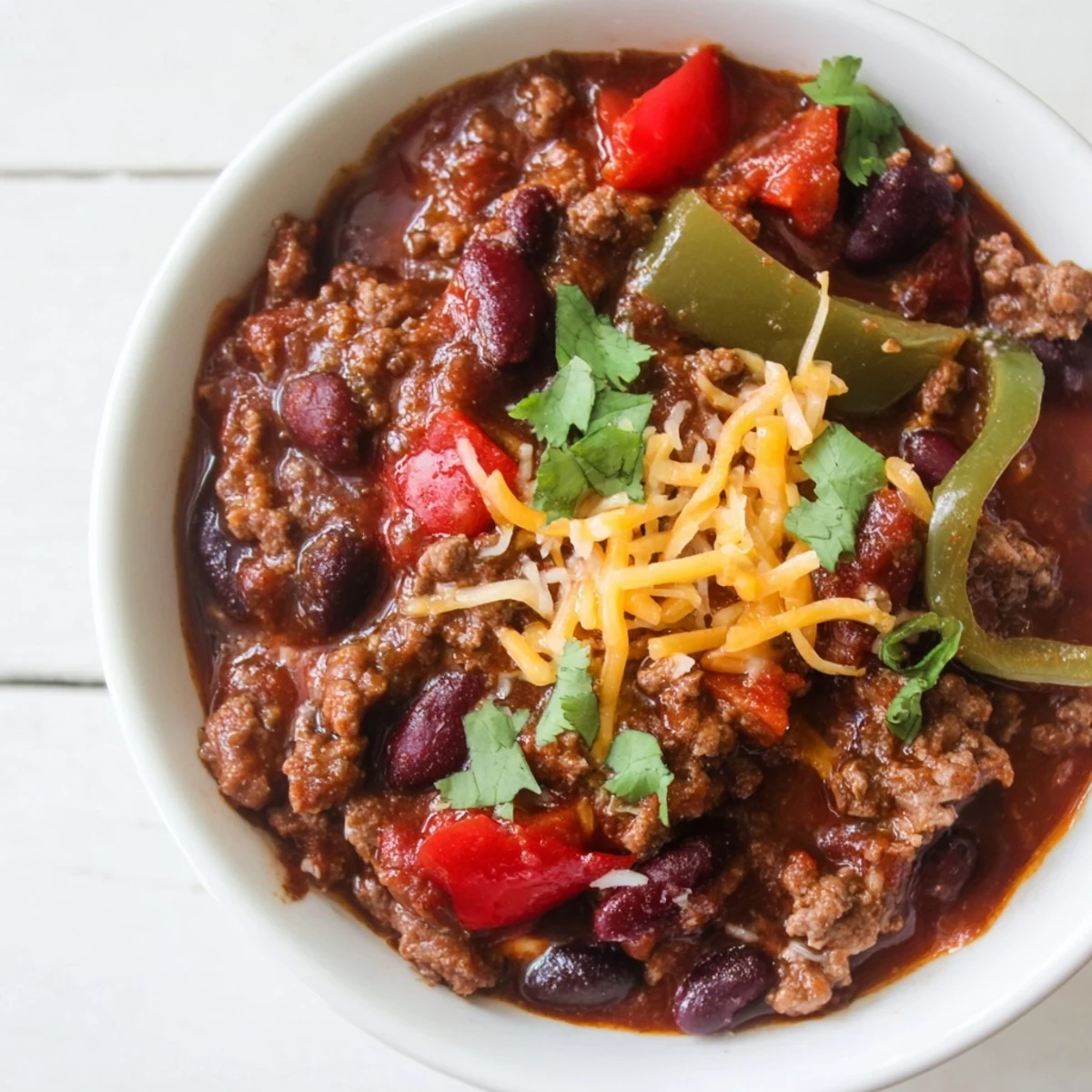 A ladle of bubbling Slow Cooker Chili with Ground Beef being scooped from a slow cooker, showcasing its rich texture and steam.