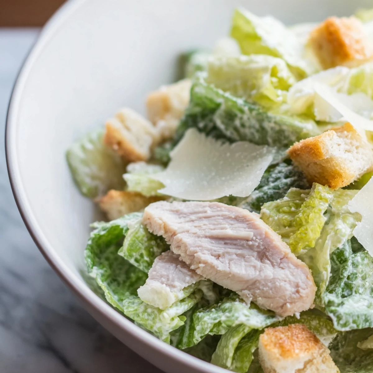 Enjoy a hearty Chicken Caesar Salad for four, featuring tender grilled chicken breast, crisp romaine, and a tangy Parmesan dressing.