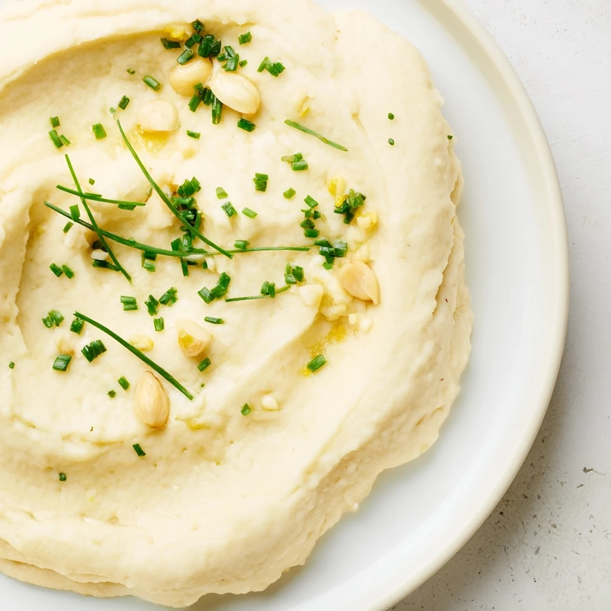 Roasted Garlic Mashed Cauliflower made from steamed cauliflower and butter, a smooth and flavorful alternative to mashed potatoes.