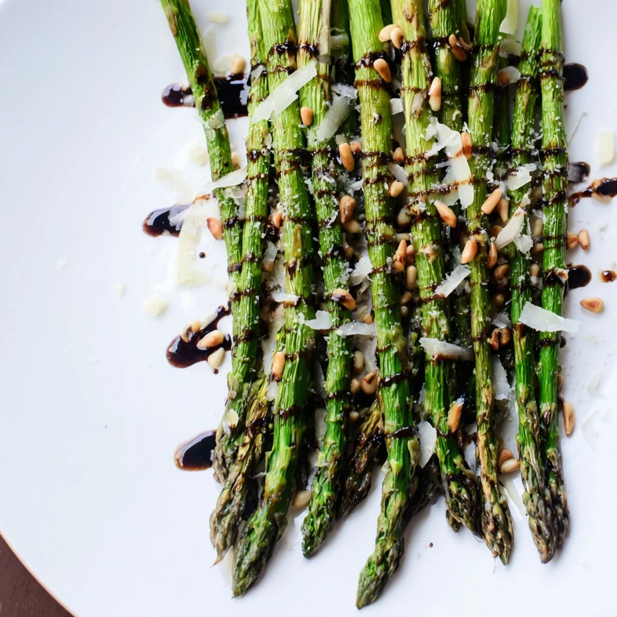 Golden roasted asparagus with balsamic glaze and shaved Parmesan, ideal spring vegetable side dish for meals.