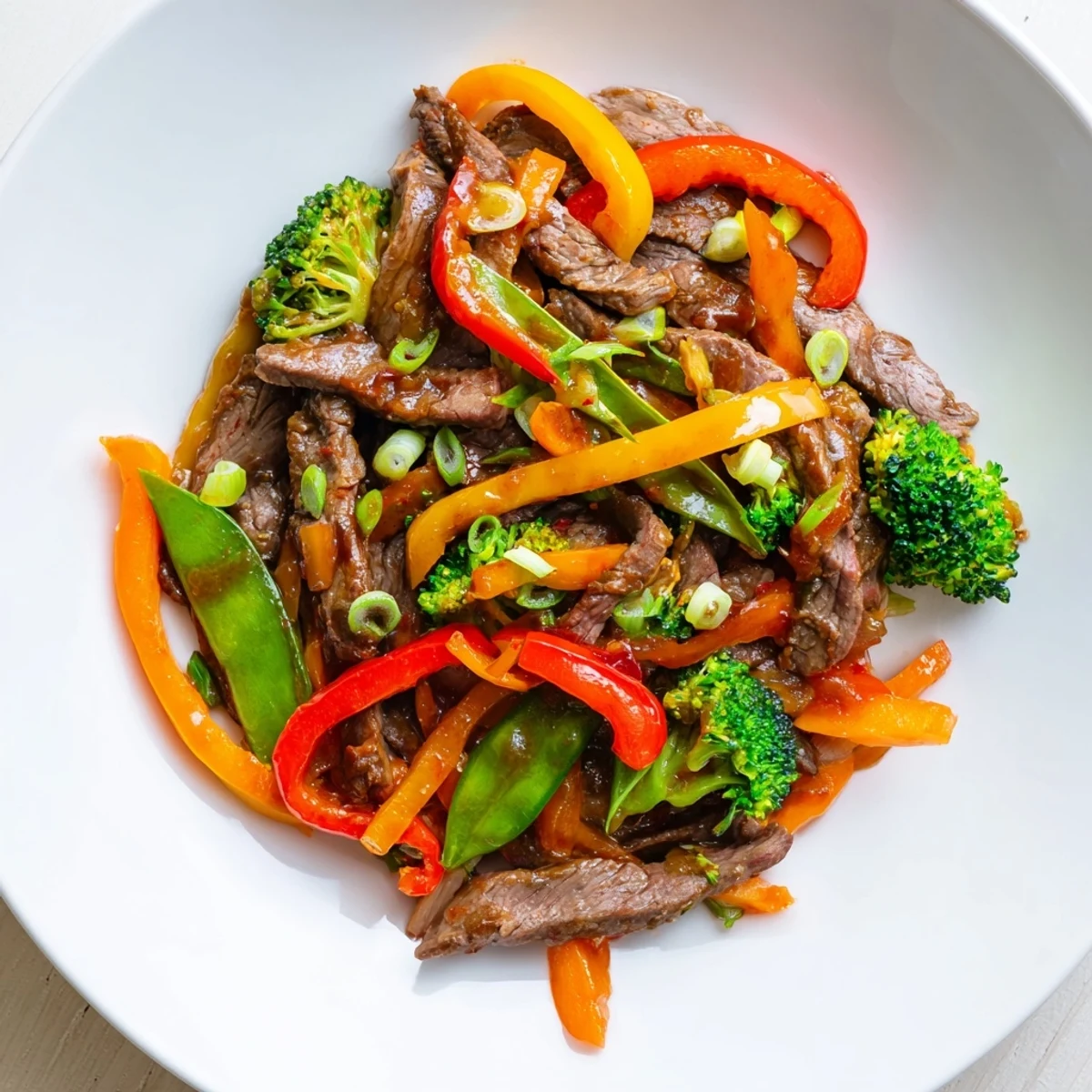 Tender beef strips and crisp broccoli in a glossy, spicy sauce for a Spicy Beef Stir Fry with Mixed Vegetables.