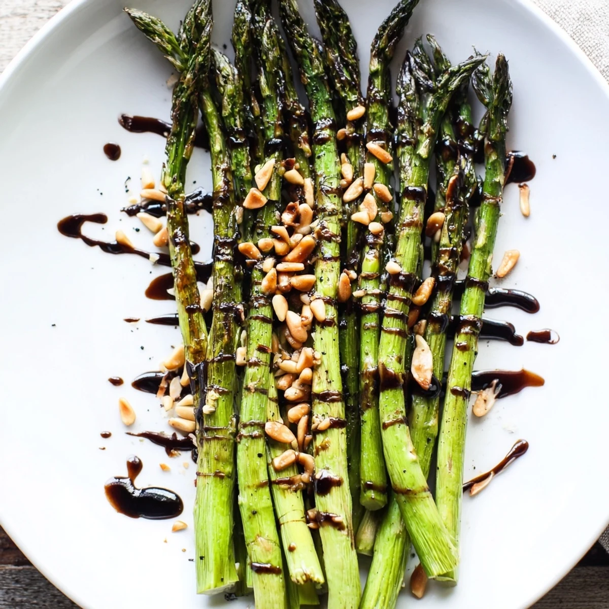 Golden roasted asparagus with balsamic reduction drizzled over tender green spears.