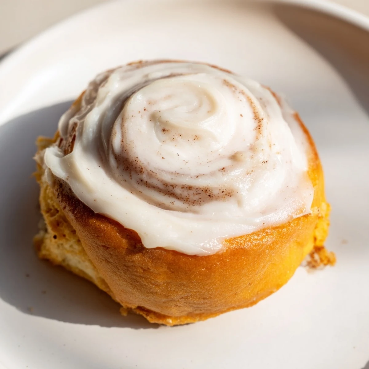 This Keto Cinnamon Bun shows its golden, tender crumb and glistening sugar-free glaze, perfect for a low-carb treat.