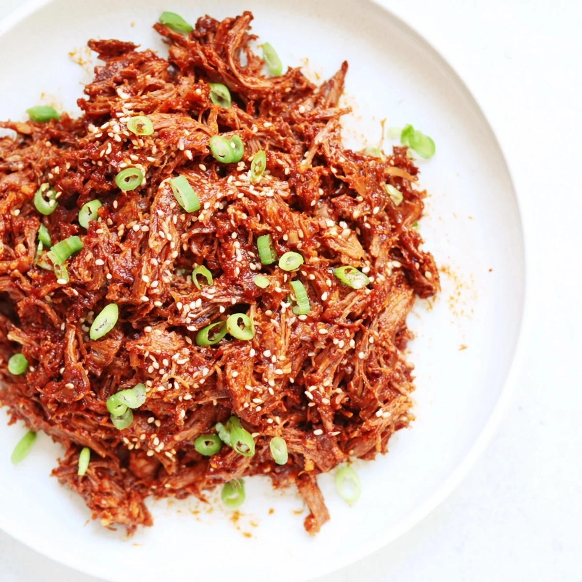 Slow Cooker Korean Beef simmering in a rich, glossy sauce with tender chunks of beef ready to serve over steamed rice.