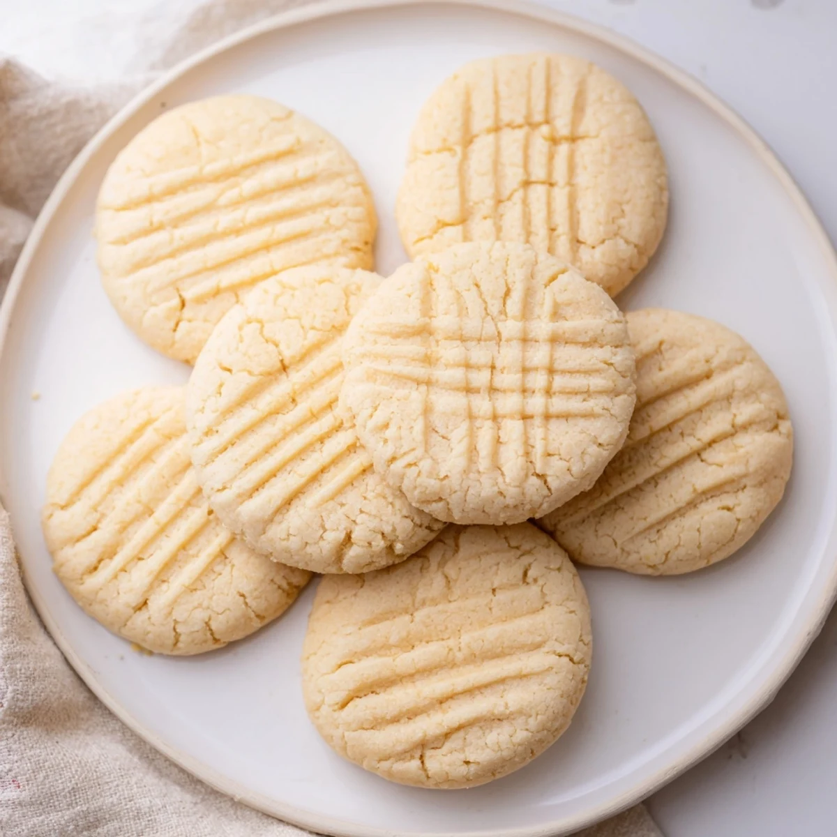Homemade Keto Butter Cookies arranged on a baking sheet lined with parchment paper, showcasing their delicate almond flour texture and rich, melt-in-your-mouth flavor.