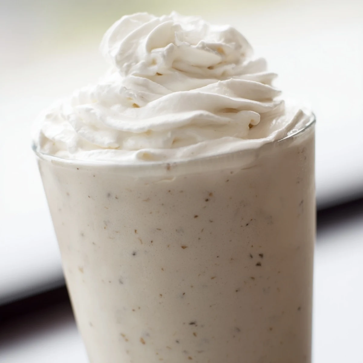 A single serving of Starbucks Vanilla Bean Frappuccino in a clear glass, looking refreshing and sweet.