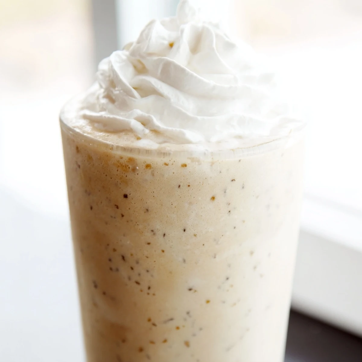 This homemade Starbucks Vanilla Bean Frappuccino recipe shows a creamy, icy texture perfect for a summer treat.