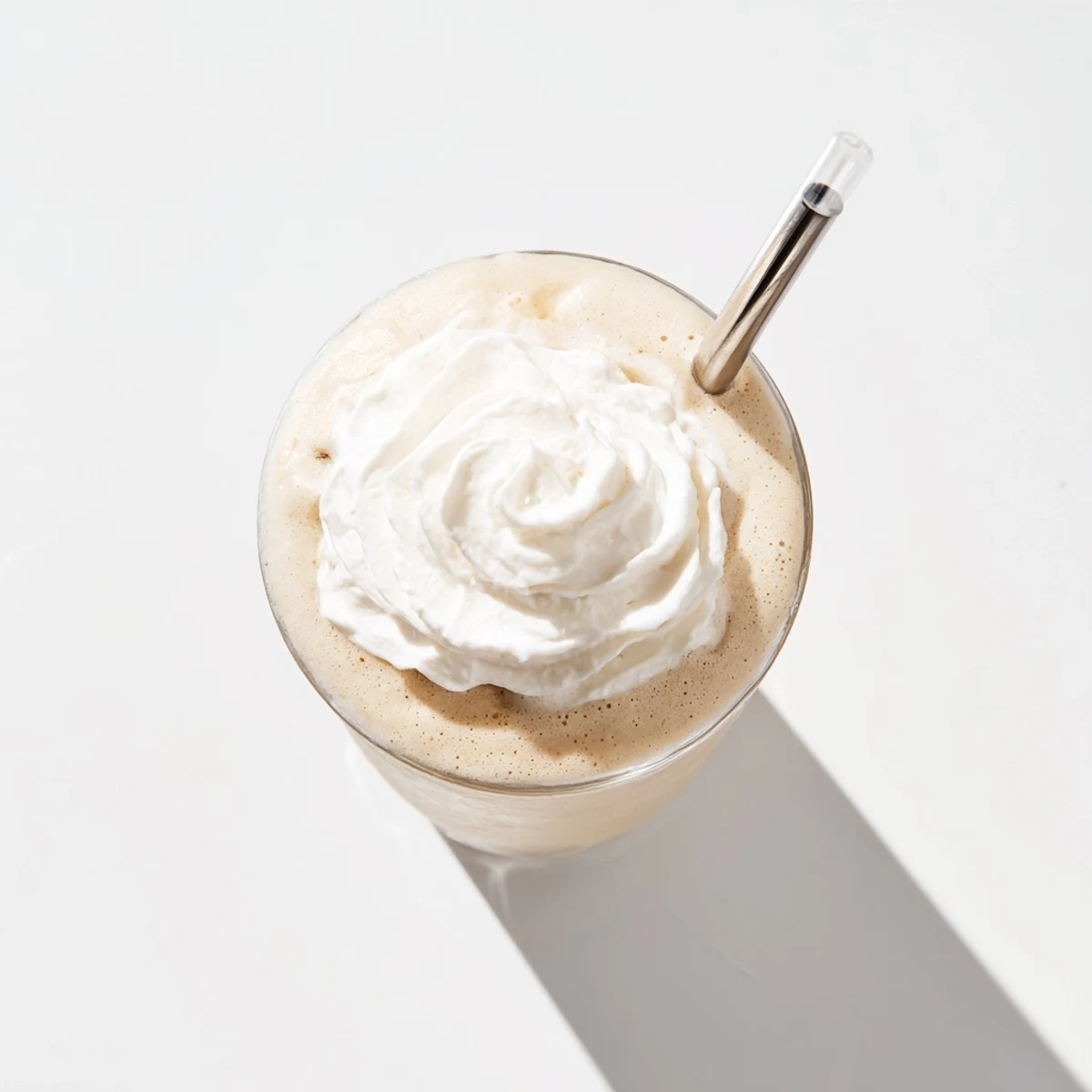 Refreshing Starbucks Vanilla Bean Frappuccino served with a straw and drizzle on top.