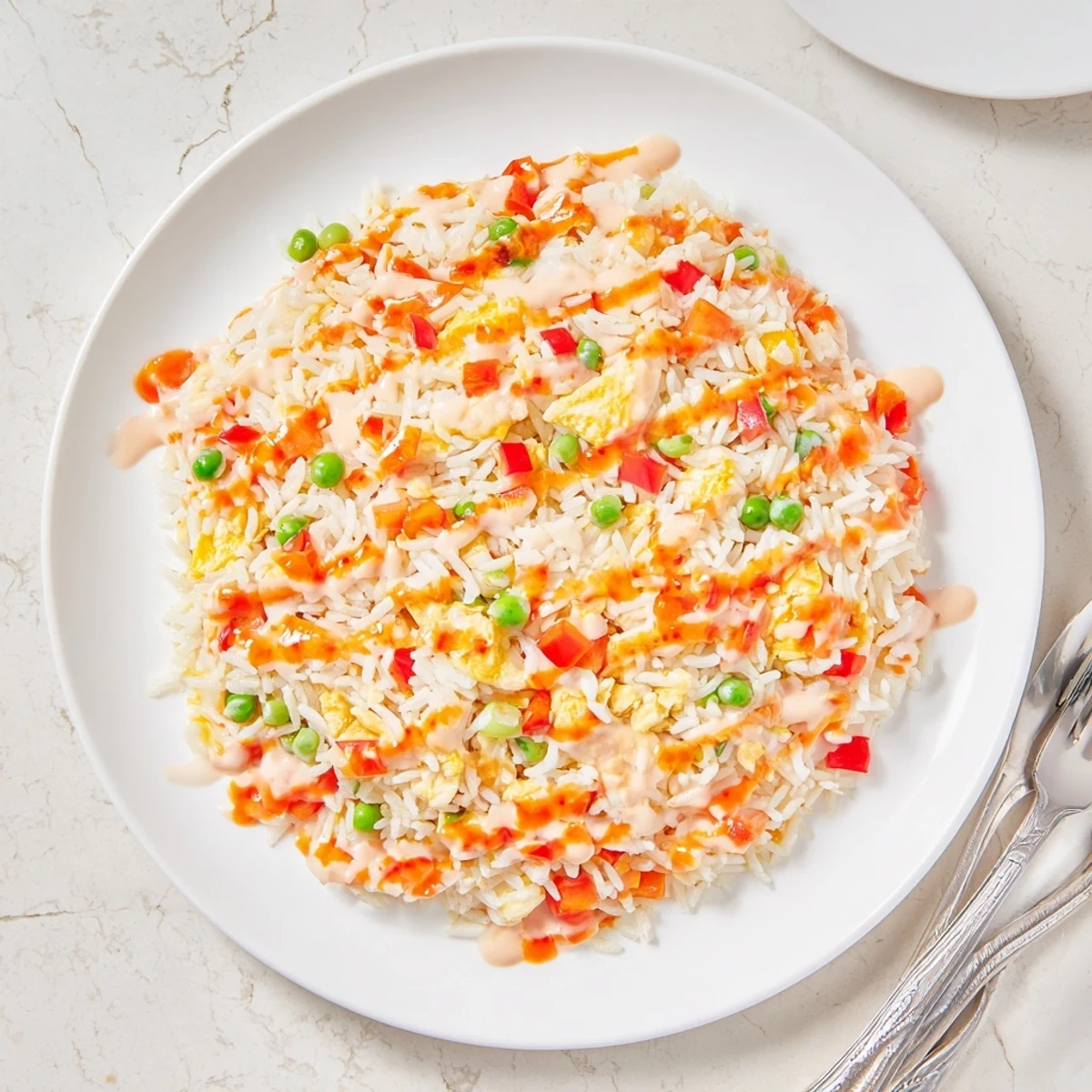 Wok-tossed Bang Bang Fried Rice featuring colorful vegetables and a spicy, creamy sauce coating.