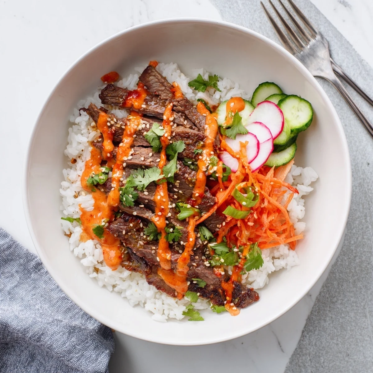 Vivid bowl of Irresistibly Easy Korean BBQ Steak Rice Bowls with Spicy Cream Sauce, garnished with fresh green onions and sesame seeds.