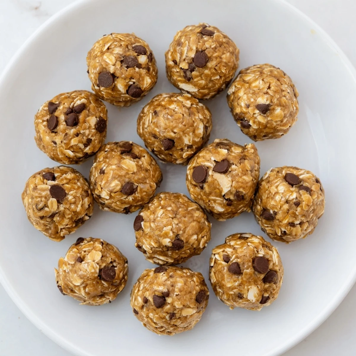 No Bake Peanut Butter Energy Bites served in a small white bowl, ready to enjoy as an afternoon energy boost.