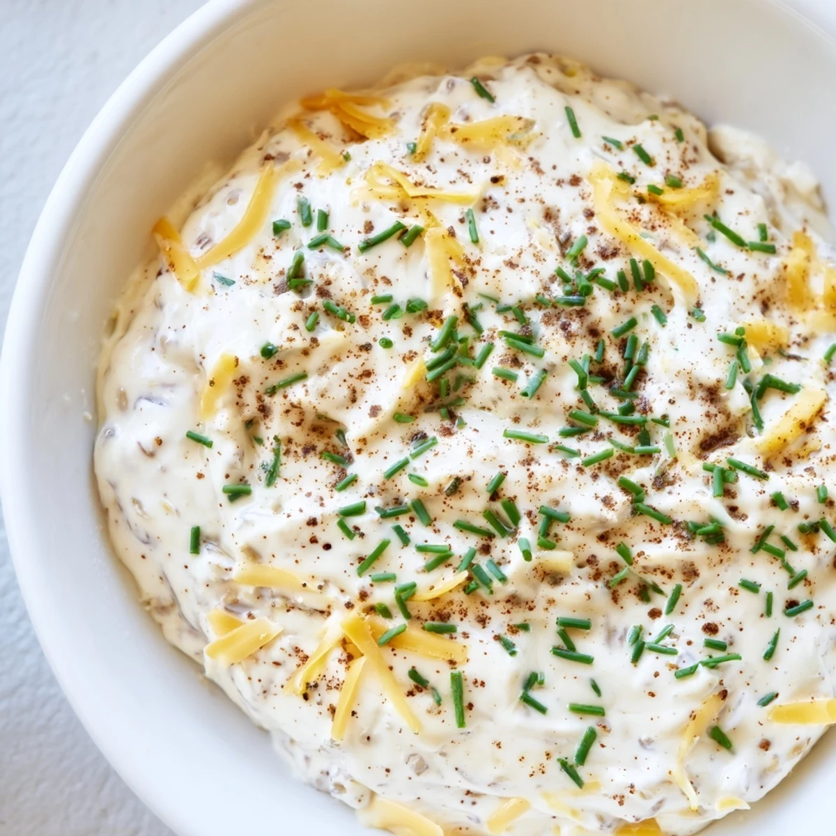 Rich and tangy savory pretzel dip with melted cheddar cheese and smoked paprika, perfect for dipping soft pretzels