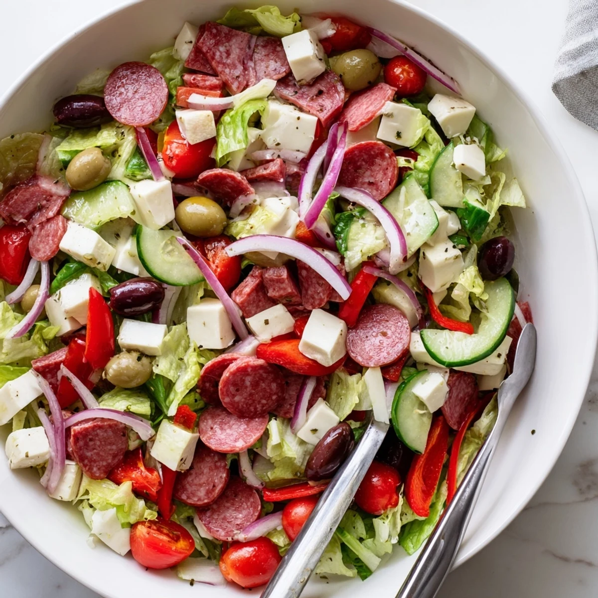 Fresh Italian chopped salad tossed with creamy mozzarella, cured meats, and bright homemade dressing