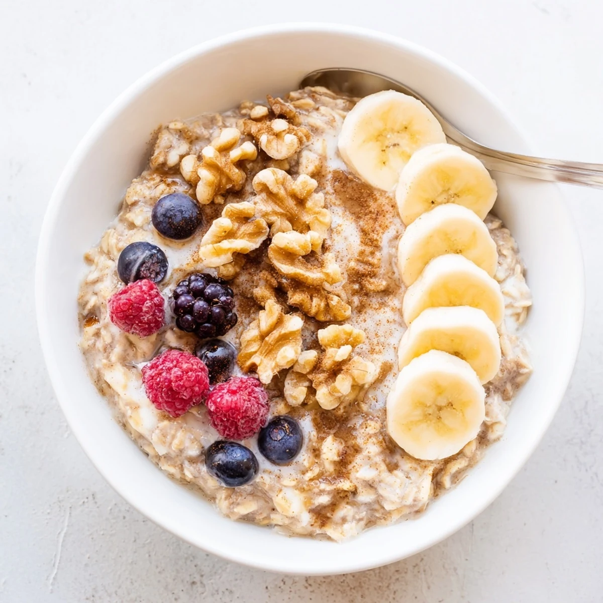 Mason jar displaying layered brown sugar overnight oats with pecans and apple slices ready for breakfast