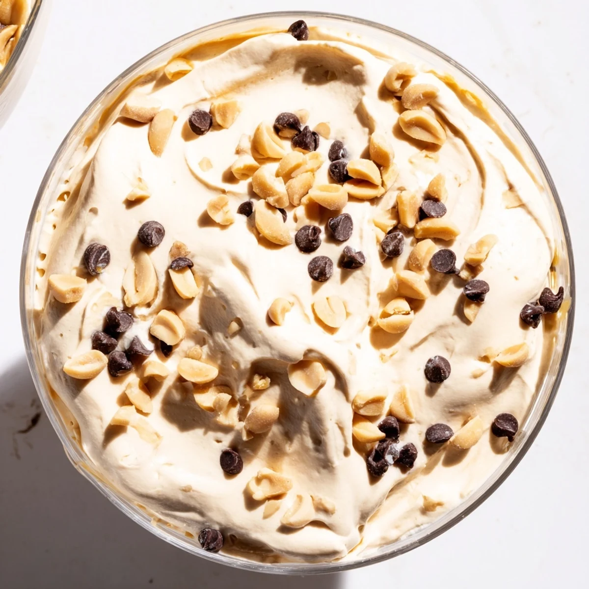 Light and fluffy peanut butter mousse dessert served in elegant glass bowls with whipped texture