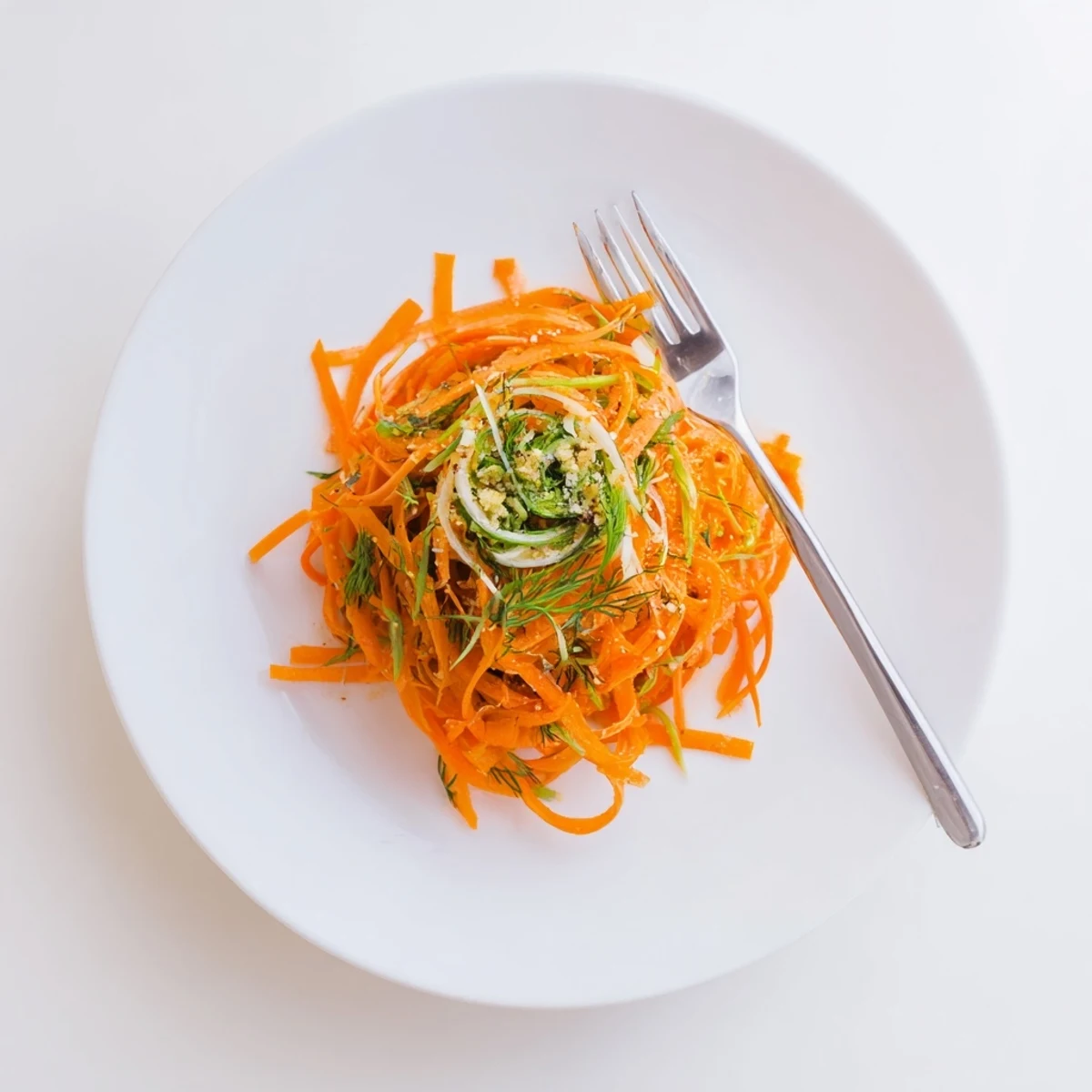 Vibrant orange carrot ribbons tossed in zesty lemon and fresh dill marinade