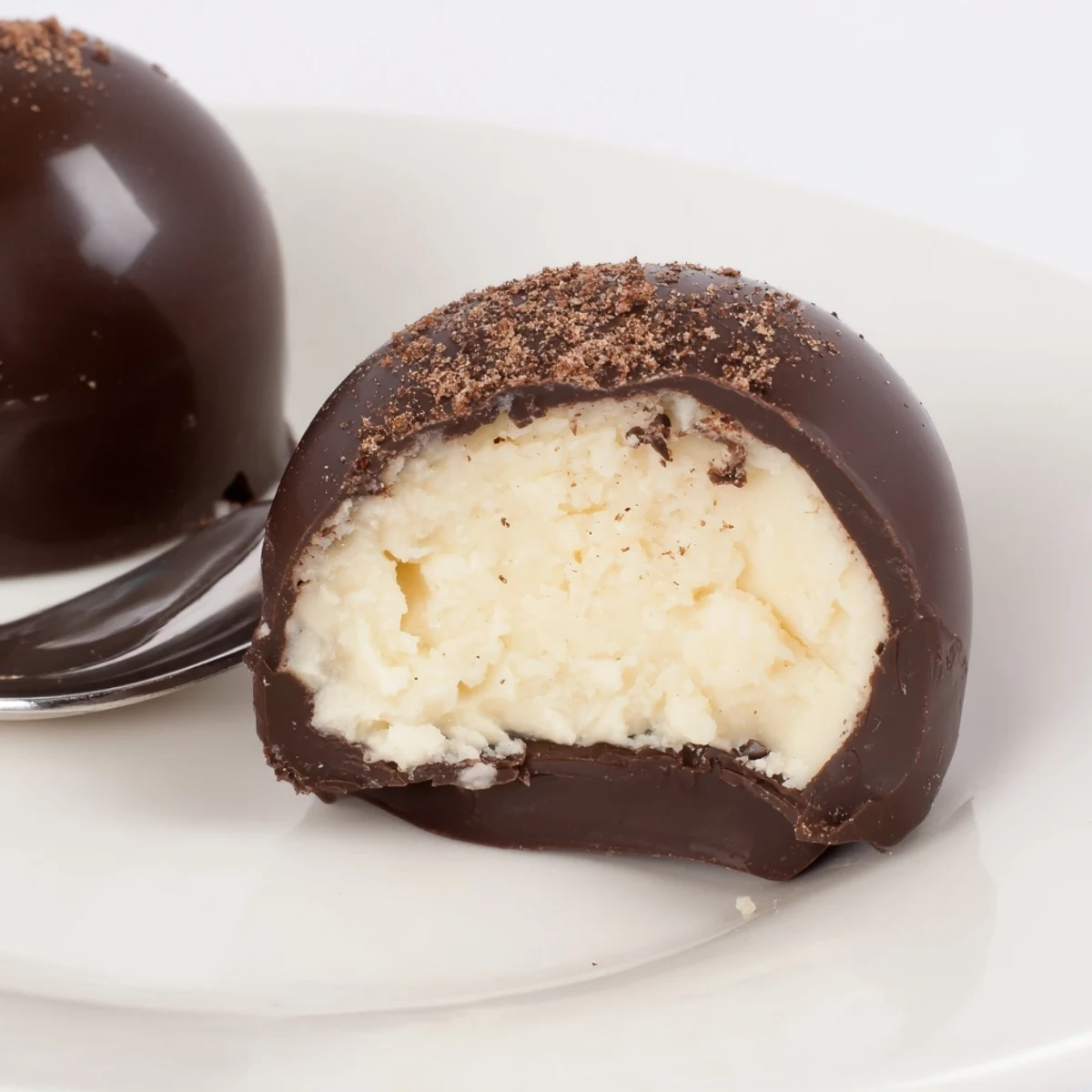 A plate of Dark Chocolate Eggnog Truffles with creamy centers and warm spices