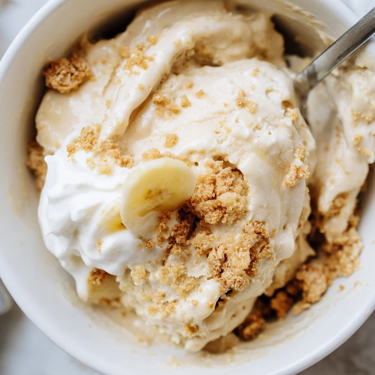 Freshly spun Ninja Creami Banana Cream Pie Ice Cream garnished with banana slices