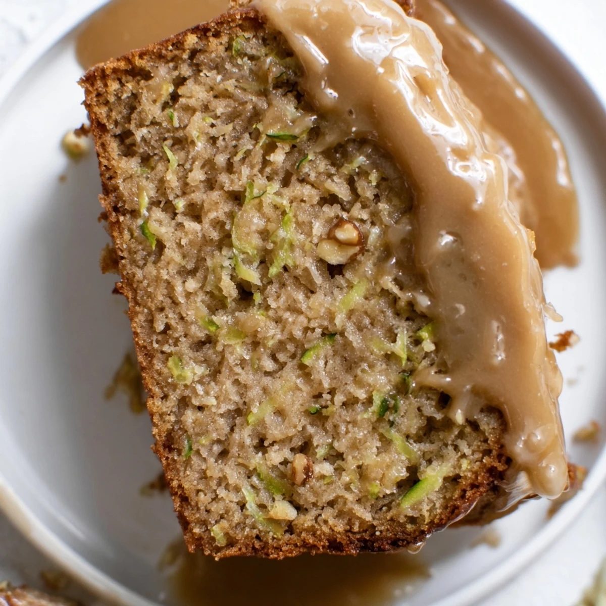 Tender Zucchini Cake With Brown Sugar Icing, buttery sweet frosting and chopped pecans.