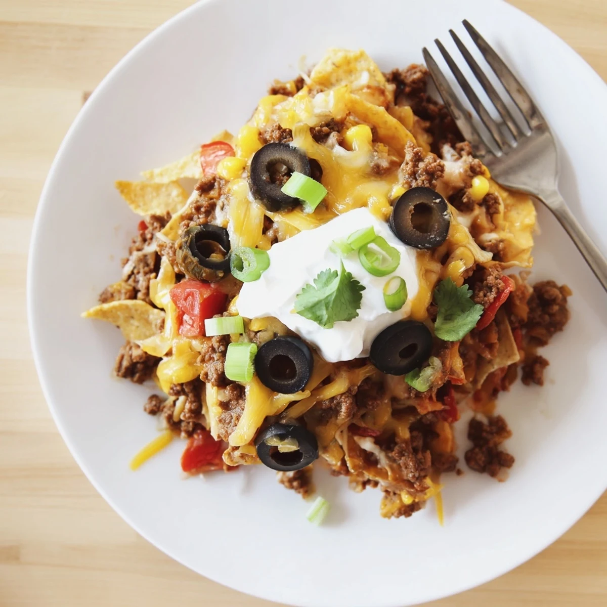 Cheesy Nacho Casserole bubbling with golden melted cheese and crisp chips.