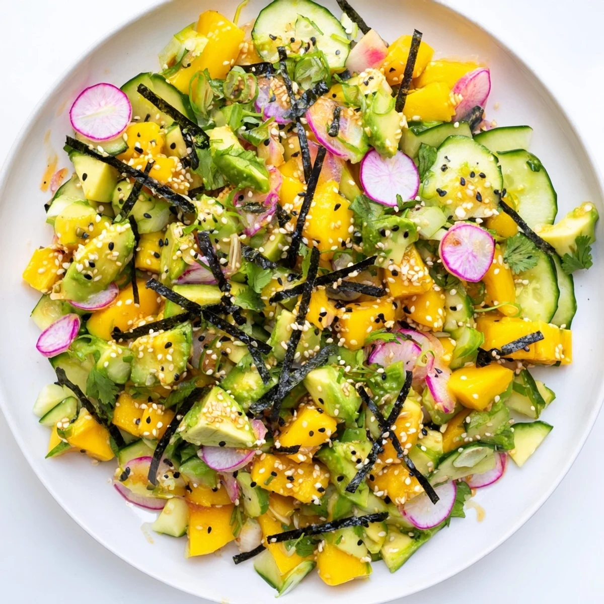 Fresh avocado mango poke salad bowl with colorful diced vegetables and sesame seed garnish