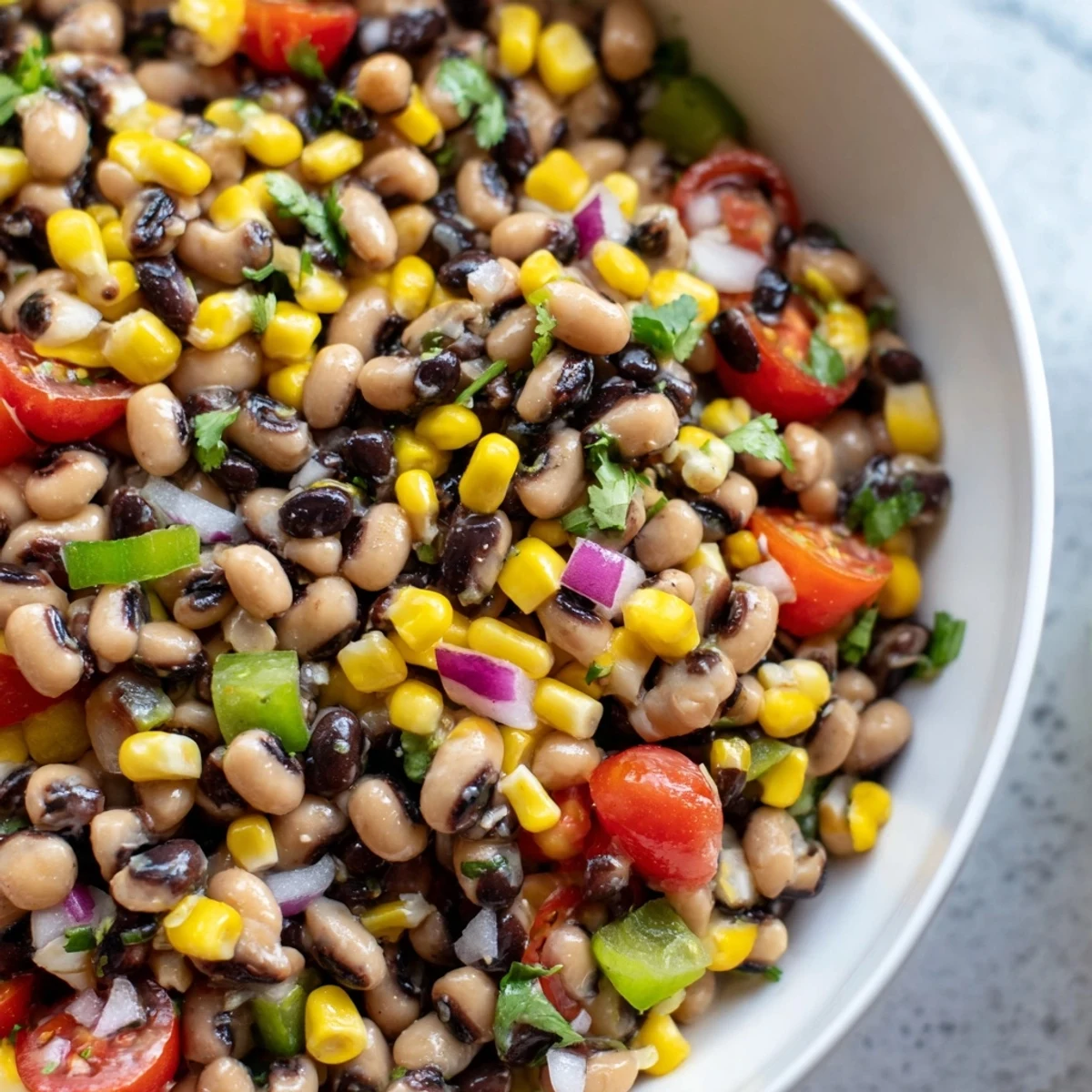 Creamy avocado-topped Cowboy Caviar served as a vibrant Tex-Mex party dip