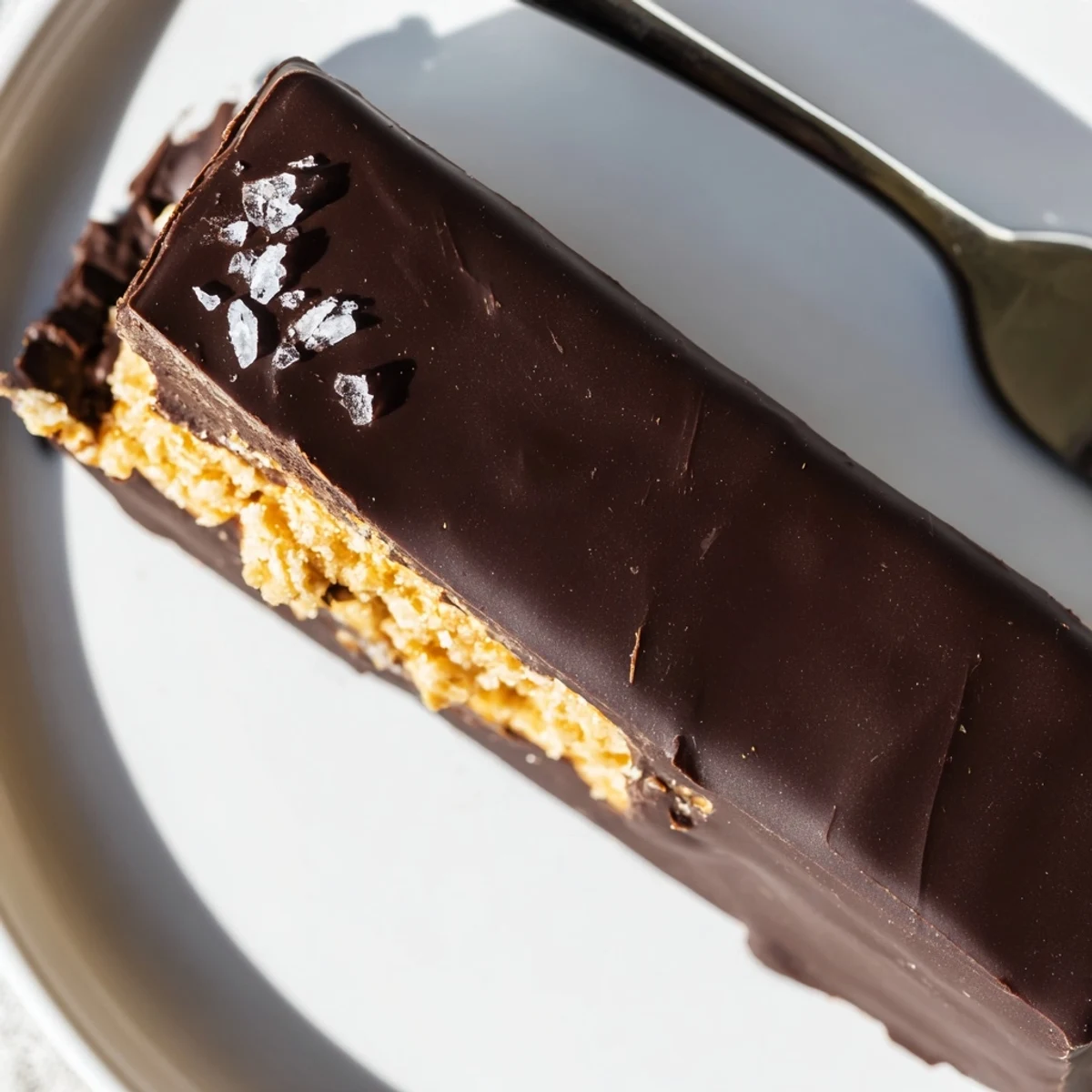 Healthy homemade Butterfingers cut into neat squares with a thick shiny chocolate shell