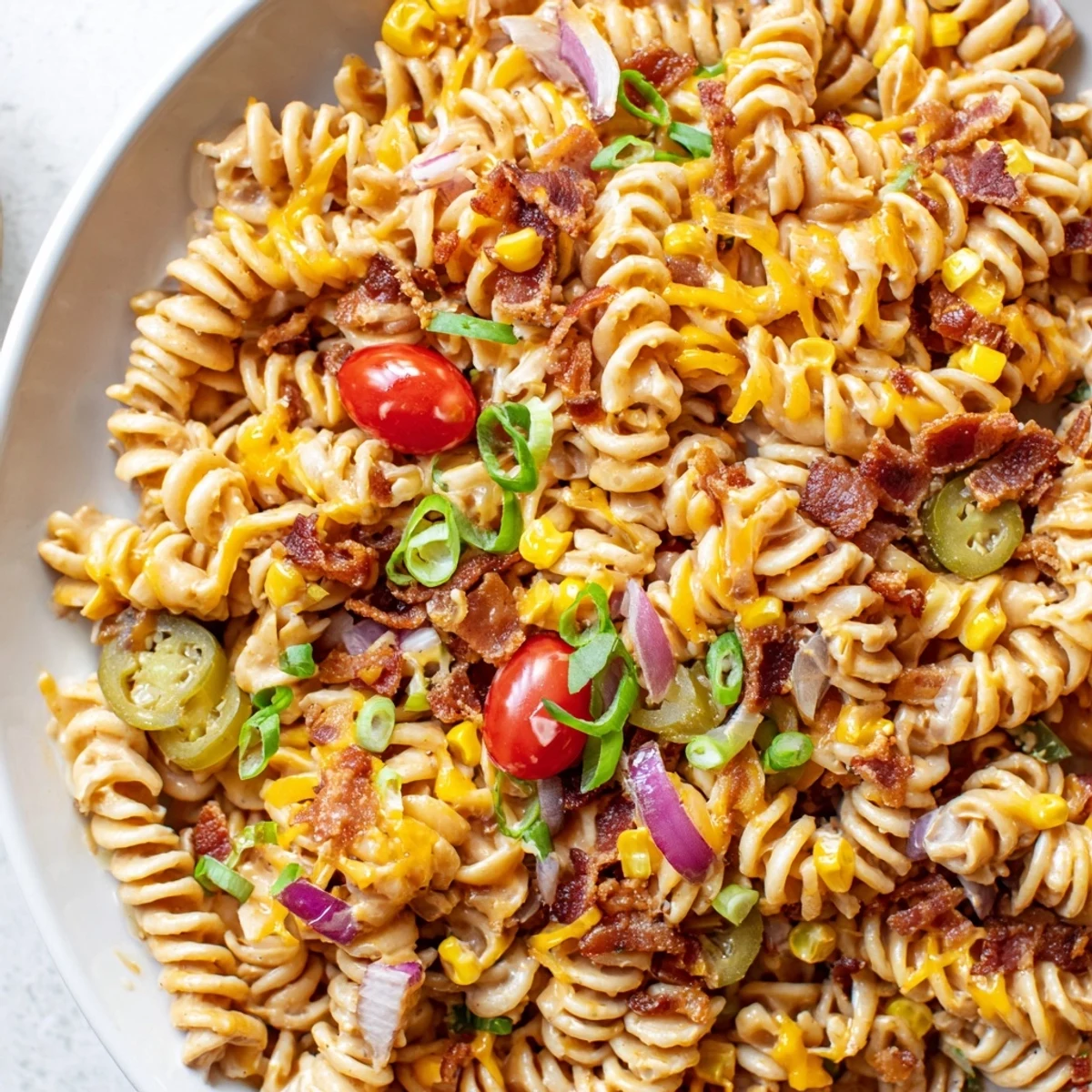 A vibrant Cowboy Pasta Salad loaded with beef, bacon, and sweet corn in a creamy BBQ ranch dressing.