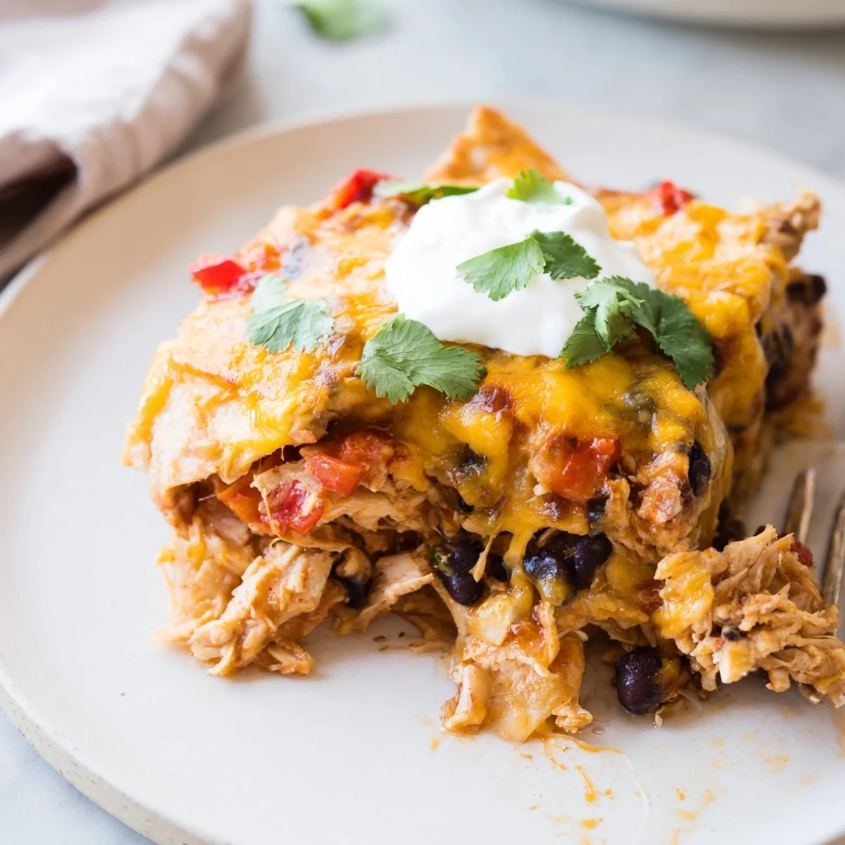 Golden bubbling chicken burrito casserole with melted cheddar and fresh cilantro garnish