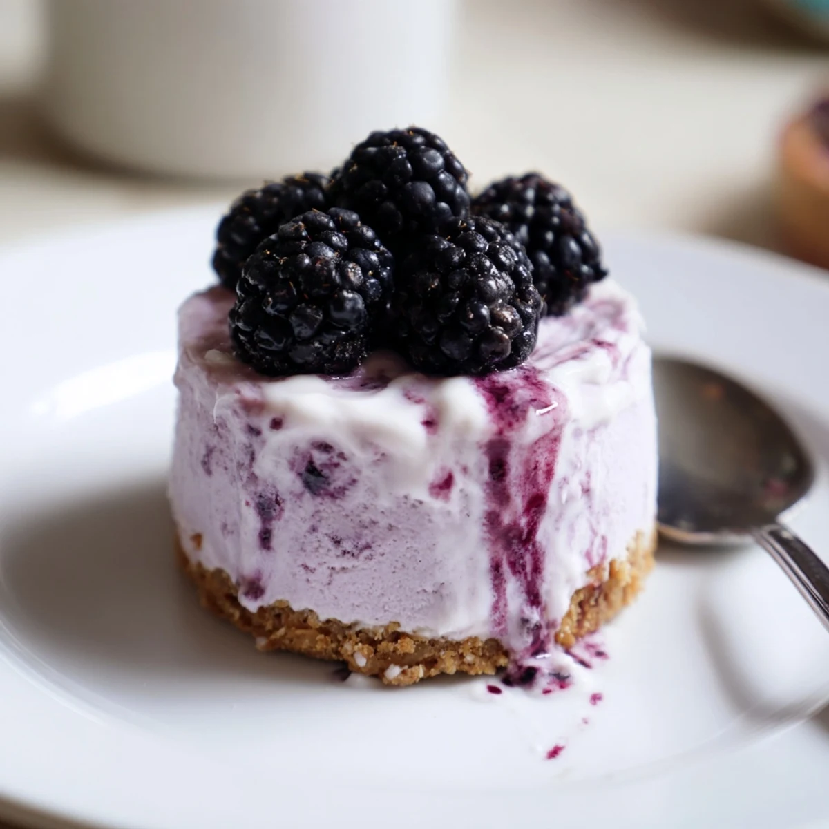 Creamy No Bake Mini Blackberry Lavender Cheesecakes topped with fresh berries and drizzled sauce