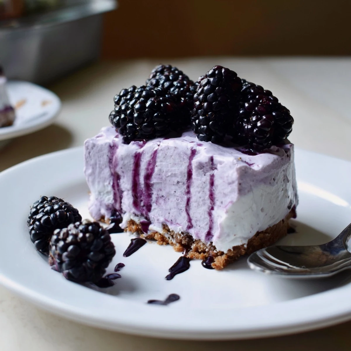 Velvety purple swirls of Creamy No Bake Mini Blackberry Lavender Cheesecakes in buttery graham crusts