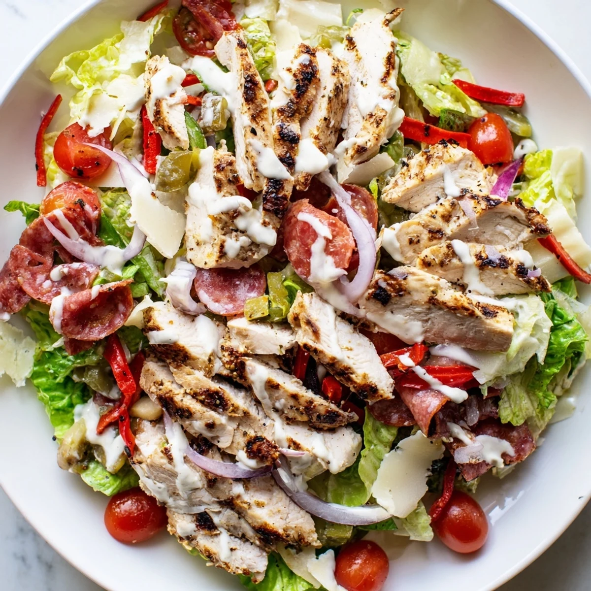 Juicy grilled chicken tops this vibrant Italian Grinder Chicken Salad drizzled with zesty dressing.