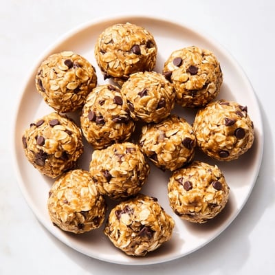 A batch of No Bake Peanut Butter Energy Bites arranged on a cooling rack, perfect for a quick, healthy snack on the go. 