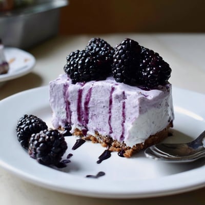 Velvety purple swirls of Creamy No Bake Mini Blackberry Lavender Cheesecakes in buttery graham crusts