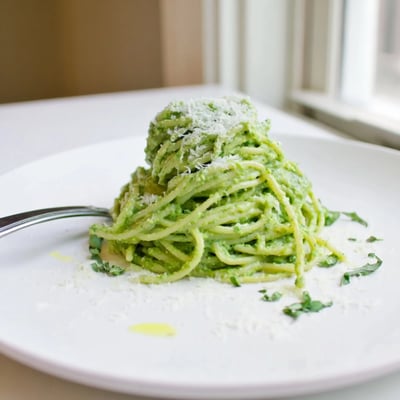 Vibrant green goddess pasta sauce blended smooth with avocado basil and lemon